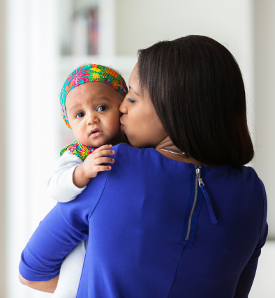 mom kissing baby